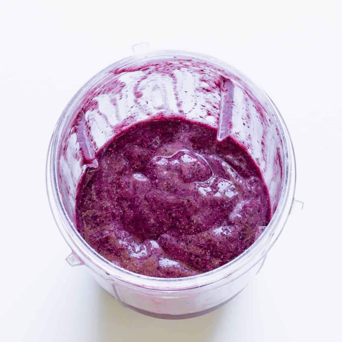 A blender jar with smooth, blended blueberry chia pudding