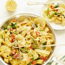 An overhead shot of a pan of one pot pappardelle pasta primavera