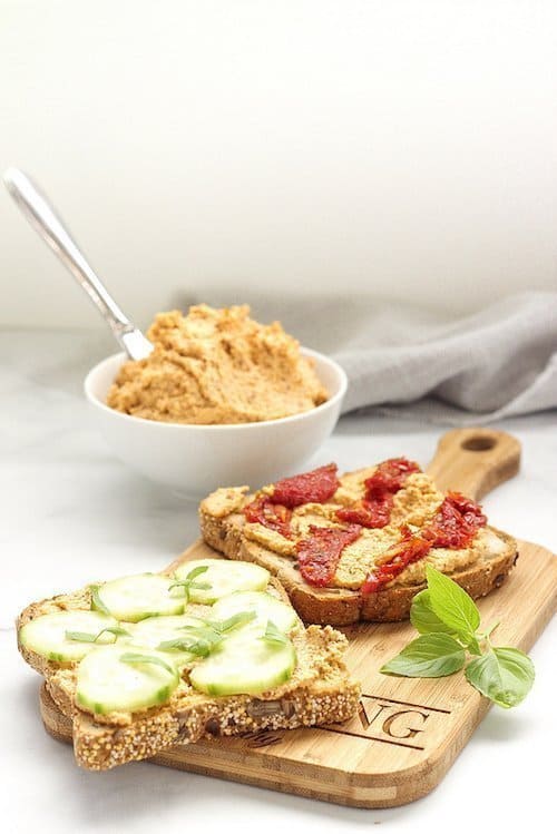 bowl of vegan almond cheese used as a topping on toast with vegetables