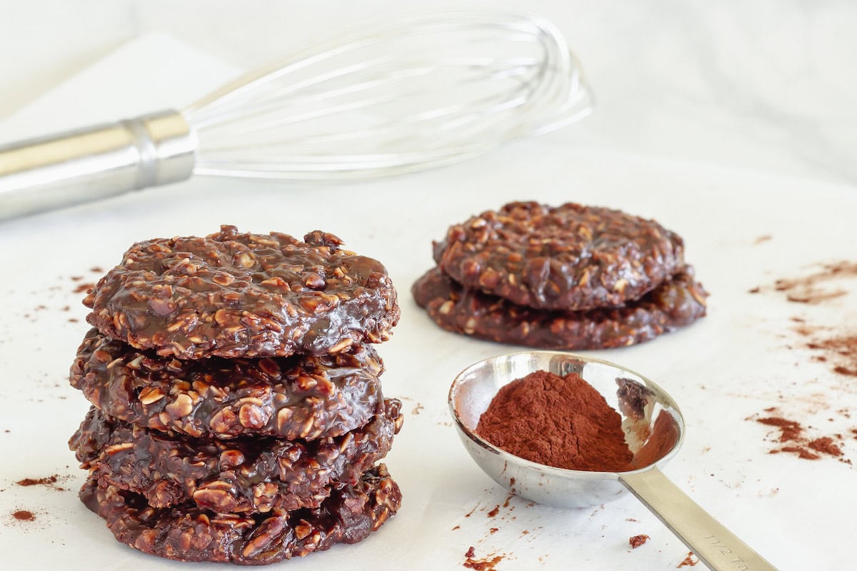 A stack of no-bake chocolate peanut butter cookies on a white background.