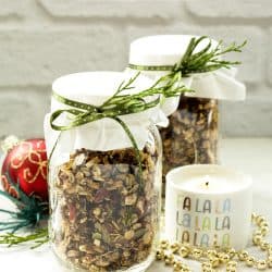 2 mason jars with granola surrounded by christmas ornaments