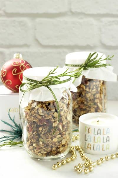 2 mason jars with granola surrounded by christmas ornaments