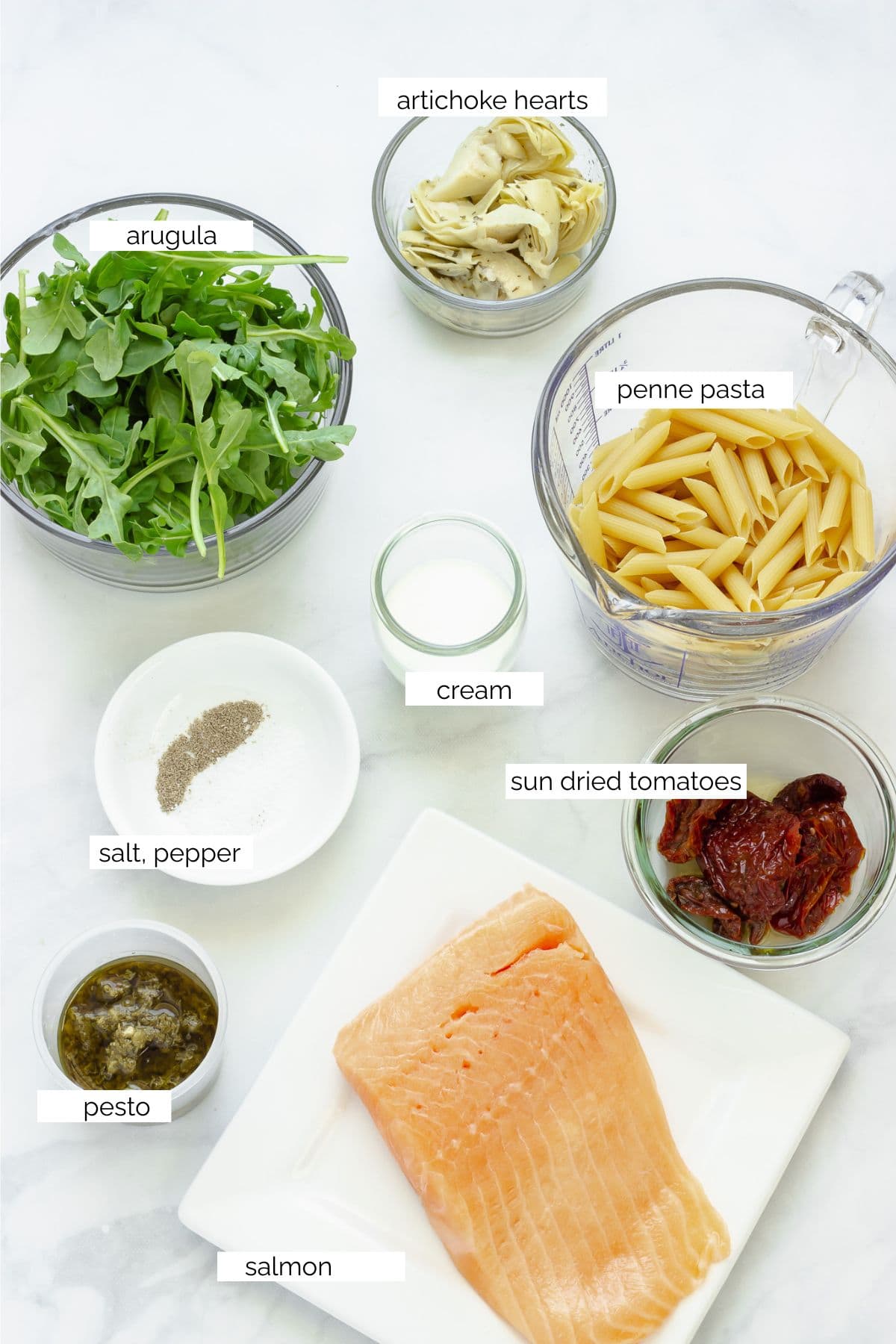 Ingredients needed to make salmon pesto pasta.