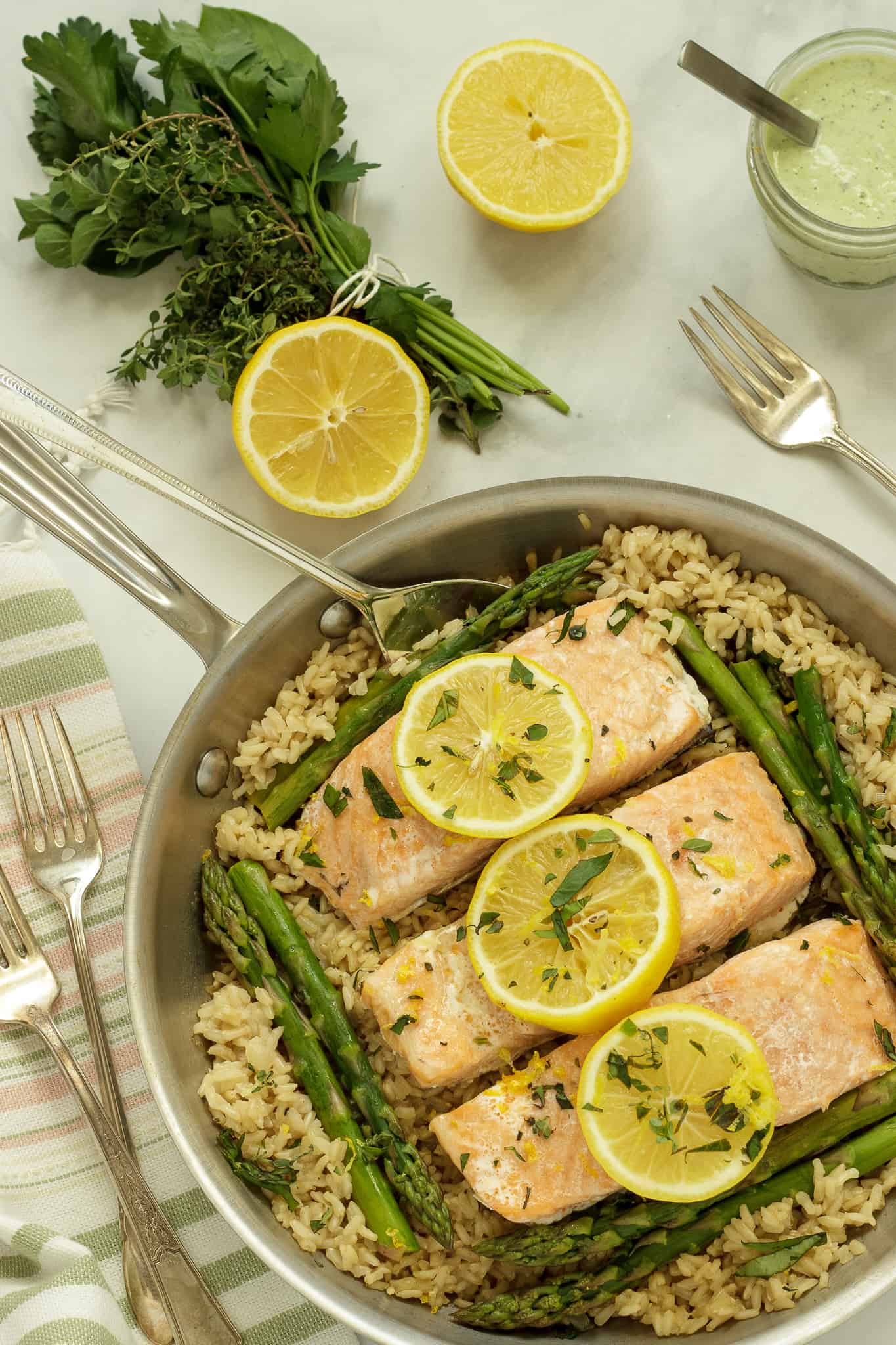 Overhead shot of a pan of salmon with brown rice and asparagus