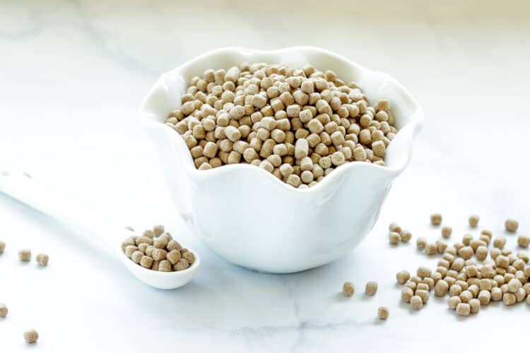 A small white bowl of uncooked Israeli Couscous
